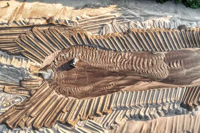 Aerial view of sand mining operations with machinery and patterned landscape in Reads Landing, MN.